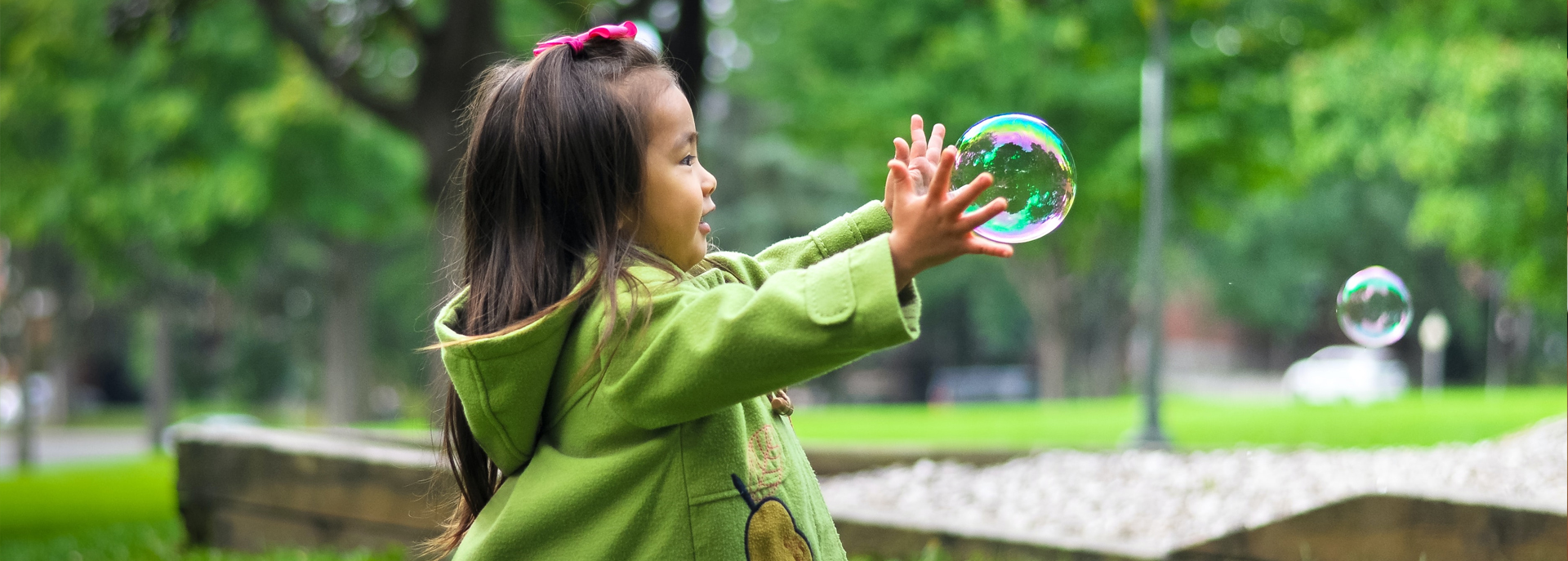 Child catching bubbles